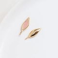 Detailed macro view of asymmetric gold leaf earrings with pink enamel finish - Pink Rabbit Ears