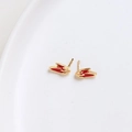 Detail shot of gold-plated rabbit ear hairpins with red enamel inlay on white plate - K Gold Rabbit Ear