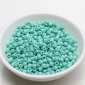 Close-up of 4mm mint green seed beads in a white bowl for DIY jewelry making - 4mm / Aqua Green