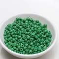 Close-up of 4mm green seed beads in a white bowl for DIY jewelry making material - 4mm / Scallion Green