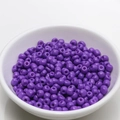 Macro shot of 4mm purple round glass seed beads in a white bowl for DIY jewelry making - 4mm / Deep purple