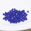 Macro detail of 4mm deep blue seed beads for DIY jewelry making piled on a white plate - 4mm / Dark Blue