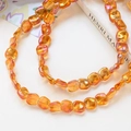 Macro detail of iridescent amber glass cube beads with rainbow shimmer for DIY jewelry - 9# Orange