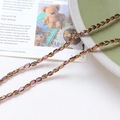 Detail of vintage purple crystal and gold beads for DIY jewelry making on a green plate - Purple
