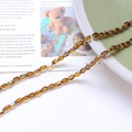 Macro detail of amber crystal beads on a ceramic plate for DIY jewelry making - Brown