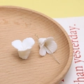 Macro shot of white resin flower charms with gold hooks for DIY jewelry crafting - 4#