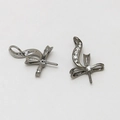 Detailed close-up of gunmetal bow-shaped jewelry charms with white zircon inlay settings - Rhinestone Inlaid Clasp / Gunmetal