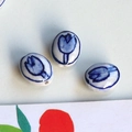 Detail of three handmade ceramic oval beads with hand-painted blue tulips for DIY jewelry - 4# Blue Flower Oval Small