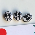 Macro view of three oval ceramic tulip beads with glossy glaze for DIY jewelry making - 5# Black Double Flower Oval Large