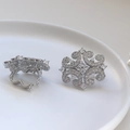 Detail view of vintage silver-plated hollow clip-on earrings with pavé zircon stones - Silver