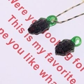 Detailed view of handmade purple grape glass pendant charm with fine golden chain - Grapes