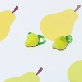 Macro detail of pear-shaped glass beads with green leaf loops for DIY jewelry making - Pineapple