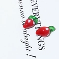 Macro view of two handmade red strawberry glass beads for DIY jewelry making - Strawberry