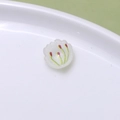 Detailed macro view of white floral resin charms with green leaves for DIY jewelry making - Patterned Petal (07#)