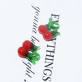 Detail shot of glass cherry charms for DIY jewelry making with green leaf and red berry - Beetroot