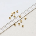 Macro detail of 14k gold-plated C-shaped crimp beads for jewelry making necklaces - 14K Gold Tone C-Shaped Crimp Cover