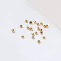 Macro shot of 18K gold-plated smooth positioning beads for DIY jewelry making accessories - 18K Gold Tone 2.0mm Crimp Bead