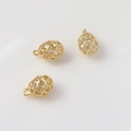 Detail view of gold plated hollow birdcage pendants with cubic zirconia for DIY jewelry - Pattern 8 (7x10mm)