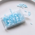 Detail view of light blue 2mm glass tube beads in a clear rectangular storage case - Blue