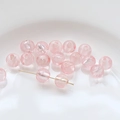Macro detail of pink translucent glass beads with silver shimmer for DIY jewelry making - Pink