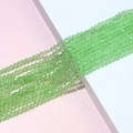 Detailed macro view of 4mm faceted grass green bicone crystal glass beads for jewelry DIY - Light Green