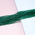 Macro shot of emerald green faceted crystal briolette beads for handmade jewelry DIY - Mint Green