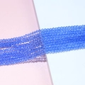 Macro shot of 4mm faceted blue crystal rondelle beads for DIY jewelry making and crafts - Blue