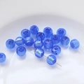 Close-up of translucent blue glass beads with silver gold-leaf foil for DIY jewelry - Blue and Purple