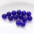 Macro shot of dark blue glass beads with gold specks and holes for DIY jewelry - Dark Blue