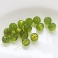 Macro view of translucent grass green glass beads with gold foil for jewelry making - Emerald Green