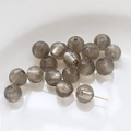 Macro detail of translucent gray glass beads with silver foil flakes for DIY jewelry - Starry Grey