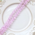 Macro detail of pink purple cracked glass beads on a vintage white ceramic plate - 1 Strand (Approx. 100-110 Beads) / Purple