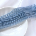 Macro shot of 2mm blue-grey iridescent glass seed beads for DIY jewelry making - Light Blue Style