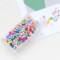 Macro shot of 3mm colorful macaron glass beads pouring from a transparent storage box - Mixed Colors