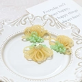 Detailed view of handmade beaded flower charms with crystals and gold lace metal base - Yellow Flower