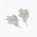 Detailed view of silver dragon wing ear accessories with realistic bone texture and pins - White K