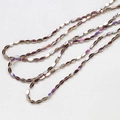 Macro detail of faceted crystal glass beads in iridescent purple and champagne gold - Iridescent Yellow