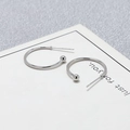 Detailed view of S925 sterling silver C-shaped hoop earrings with polished ball ends - 20mm / White Gold