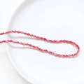 Faceted red glass rice beads in a white ceramic dish for DIY handmade jewelry crafting - Red