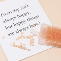 Macro view of 3mm matte orange seed beads for jewelry making with clear storage box - Orange