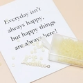 Macro detail of 3mm frosted light yellow glass beads for DIY jewelry making in a box - Beige