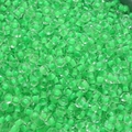 Macro view of 4mm vibrant transparent green glass seed beads for DIY jewelry making - Emerald Green
