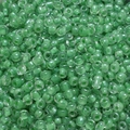 Macro detail of 4mm light green translucent glass seed beads with center hole for DIY jewelry - Dark Green