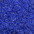 Macro detail of 4mm macaron blue glass seed beads with clear polished finish and core dyeing - 15# Blue