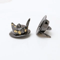 Macro shot of steampunk mini top hat charms with gold gears and goggles details - Gunmetal