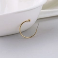 Minimalist C-shaped gold-plated open hoop earring with small bead detail on white background - 25mm / Gold