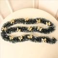 Close-up of dark green tinsel garland with snowy white edges and gold bows decor - Dark Green (With 12 Gold Bows)