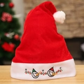 Red plush Christmas hat with embroidered snowman and lights on a wooden surface - Snowman Embroidery Style