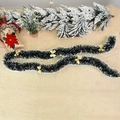 Dark green Christmas tinsel with snow tips and gold bows on a rustic linen background - Tinsel Garland with 5 Gold Bows
