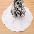 White plush Christmas tree skirt with silver sequin snowflakes on light wood floor - Silver Snowflake
